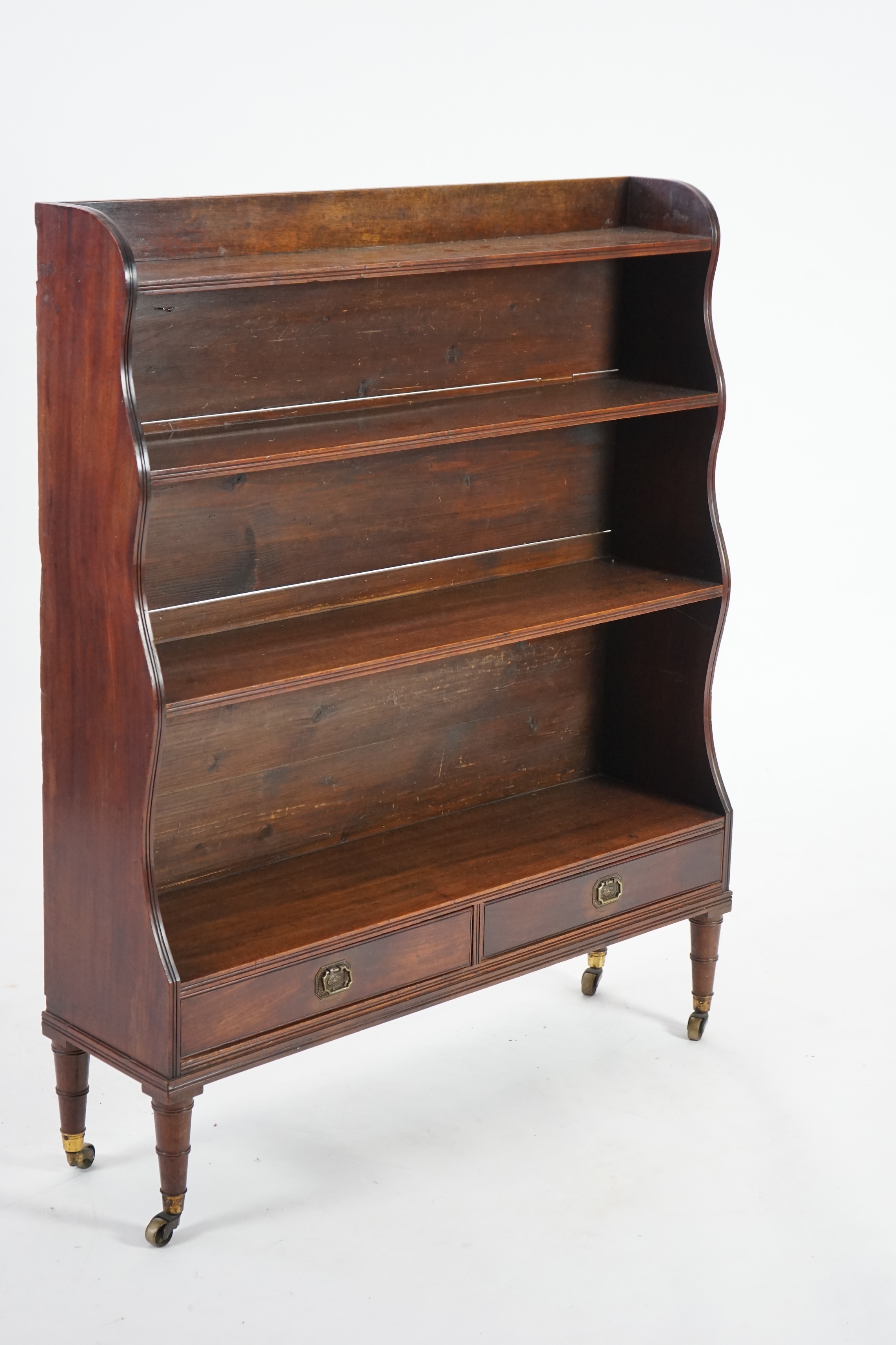 An early 19th century mahogany waterfall bookcase